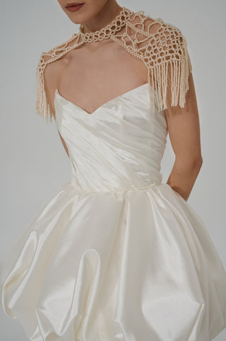 Elegant pearl backpacks with a lace-like woven structure and movable fringes that add aristocratic sophistication to the look - designer piece by Caribis