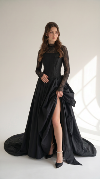 An exquisite black corset set with tulle texture and a luxurious train that creates a dramatic and architectural silhouette - designer piece by Caribis