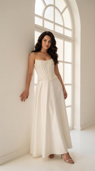 An elegant wedding set with minimalist embroidery — a corset with pearls and a straight skirt