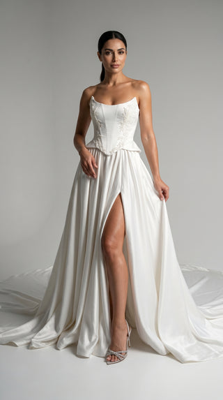 Strapless wedding dress with a basque corset, deep slit, and long train