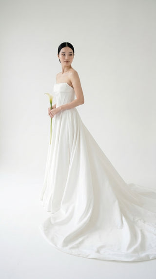 Wedding dress-transformer with a deep cut and a semi-circular long train