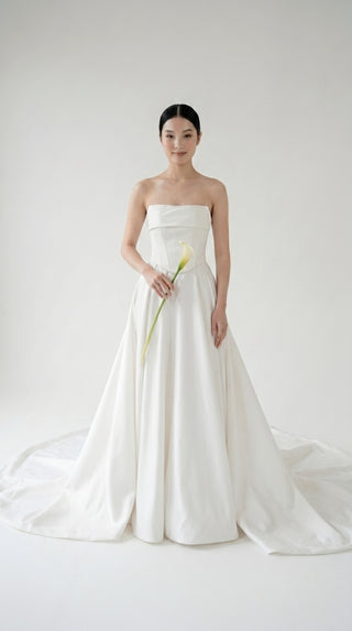 Wedding dress-transformer with a deep cut and a semi-circular long train - designer piece by Caribis