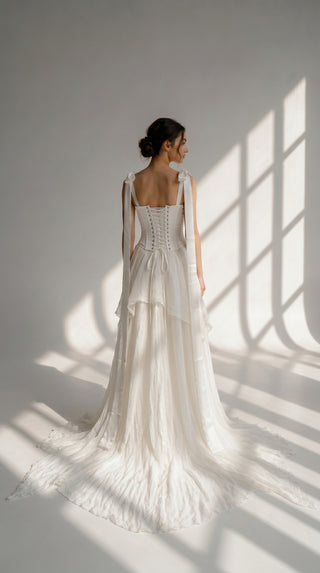 A sophisticated ivory two-piece with a structured satin bodice and a light silk skirt is a versatile choice for the modern bride - designer piece by Caribis