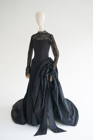 Sculptural taffeta gown with delicate lace detailing and dramatic train