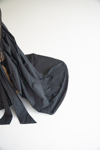 Sculptural taffeta gown with delicate lace detailing and dramatic train