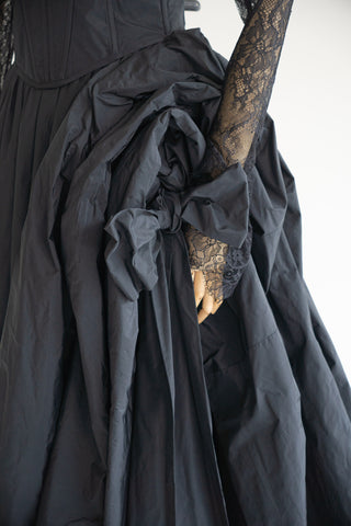 Sculptural taffeta gown with delicate lace detailing and dramatic train