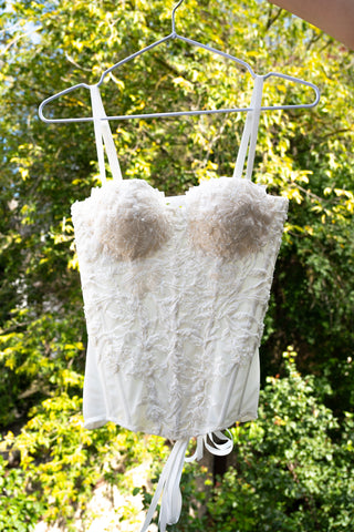 Exquisite corset with luxurious voluminous embroidery and a delicate transparent base