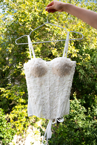 Exquisite corset with luxurious voluminous embroidery and a delicate transparent base