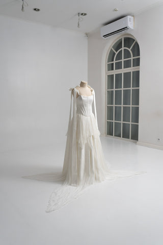 A sophisticated ivory two-piece with a structured satin bodice and a light silk skirt is a versatile choice for the modern bride