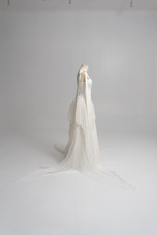 A sophisticated ivory two-piece with a structured satin bodice and a light silk skirt is a versatile choice for the modern bride