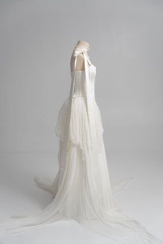 A sophisticated ivory two-piece with a structured satin bodice and a light silk skirt is a versatile choice for the modern bride