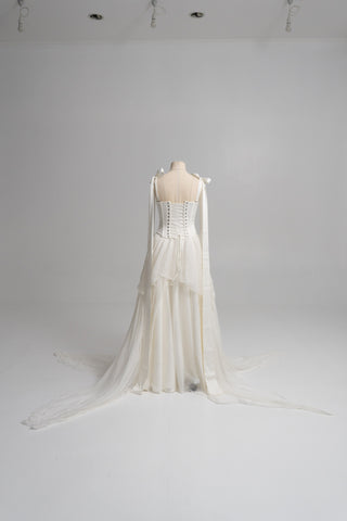 A sophisticated ivory two-piece with a structured satin bodice and a light silk skirt is a versatile choice for the modern bride