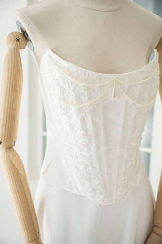 An elegant wedding set with minimalist embroidery — a corset with pearls and a straight skirt - designer piece by Caribis