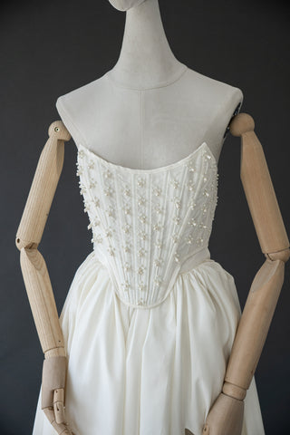 Handmade beaded corset with a long, fluffy skirt with a slit