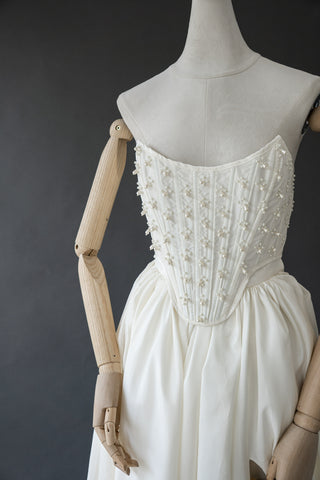 Handmade beaded corset with a long, fluffy skirt with a slit