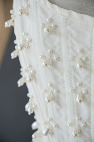 Handmade beaded corset with a long, fluffy skirt with a slit