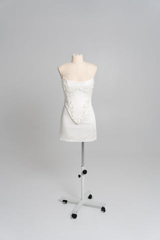 Short wedding dress with an elongated corset, floral embroidery, and an asymmetrical silhouette