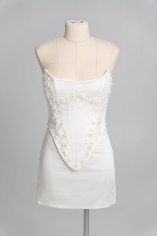 Short wedding dress with an elongated corset, floral embroidery, and an asymmetrical silhouette