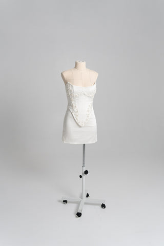 Short wedding dress with an elongated corset, floral embroidery, and an asymmetrical silhouette