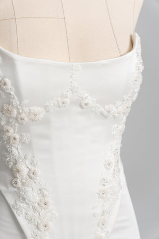 Short wedding dress with an elongated corset, floral embroidery, and an asymmetrical silhouette - designer piece by Caribis