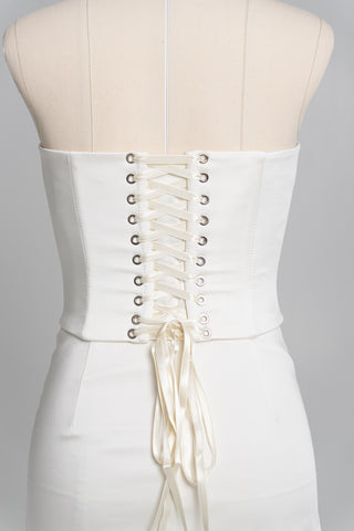 Short wedding dress with an elongated corset, floral embroidery, and an asymmetrical silhouette