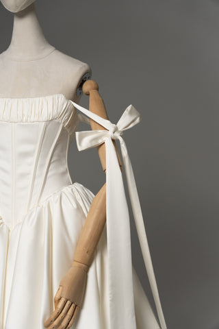 Wedding dress with a corset bodice, dropped straps, and a full skirt