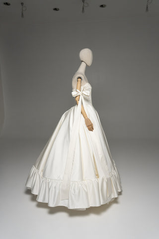 Wedding dress with a corset bodice, dropped straps, and a full skirt