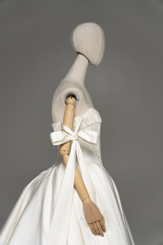 Wedding dress with a corset bodice, dropped straps, and a full skirt