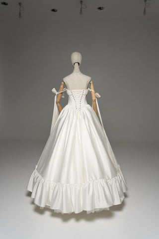 Wedding dress with a corset bodice, dropped straps, and a full skirt
