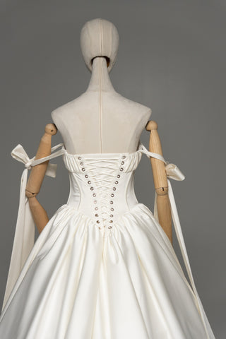 Wedding dress with a corset bodice, dropped straps, and a full skirt