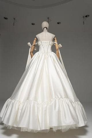 Wedding dress with a corset bodice, dropped straps, and a full skirt