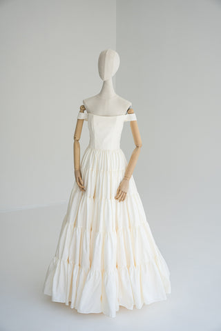 Wedding dress with taffeta bodice — features open shoulders, tiered hem, and multi-layered skirt