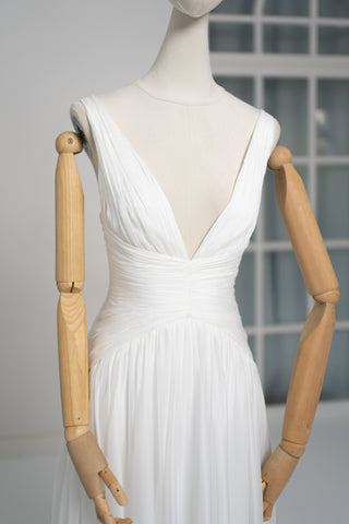 A light dress with draping and an open back that combines femininity and comfort - designer piece by Caribis