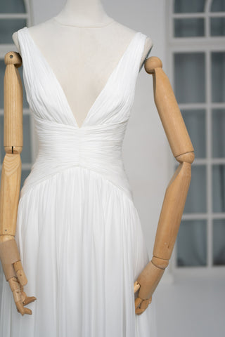 A light dress with draping and an open back that combines femininity and comfort