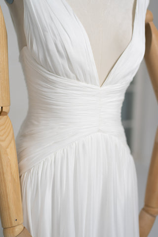 A light dress with draping and an open back that combines femininity and comfort