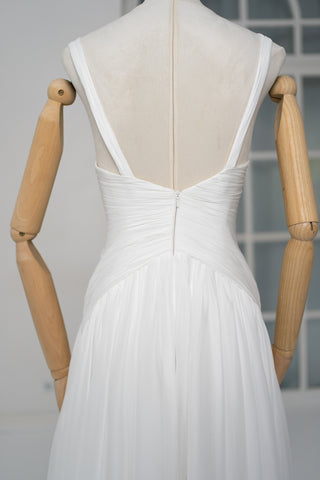 A light dress with draping and an open back that combines femininity and comfort