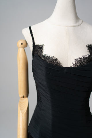 An exquisite black corset set with tulle texture and a luxurious train that creates a dramatic and architectural silhouette