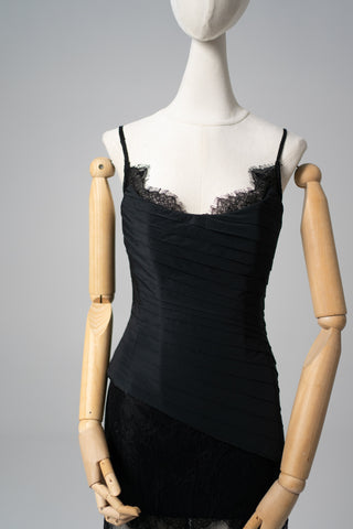 An exquisite black corset set with tulle texture and a luxurious train that creates a dramatic and architectural silhouette