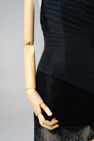 An exquisite black corset set with tulle texture and a luxurious train that creates a dramatic and architectural silhouette