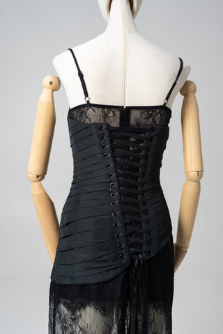 An exquisite black corset set with tulle texture and a luxurious train that creates a dramatic and architectural silhouette