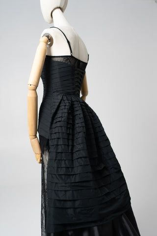 An exquisite black corset set with tulle texture and a luxurious train that creates a dramatic and architectural silhouette