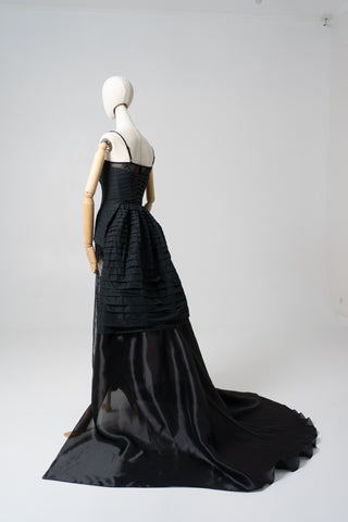 An exquisite black corset set with tulle texture and a luxurious train that creates a dramatic and architectural silhouette