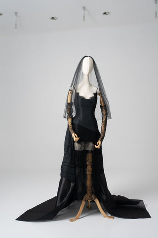 An exquisite black corset set with tulle texture and a luxurious train that creates a dramatic and architectural silhouette