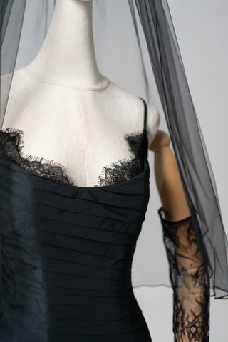 An exquisite black corset set with tulle texture and a luxurious train that creates a dramatic and architectural silhouette