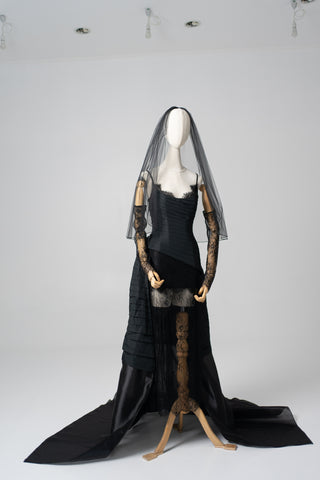 An exquisite black corset set with tulle texture and a luxurious train that creates a dramatic and architectural silhouette