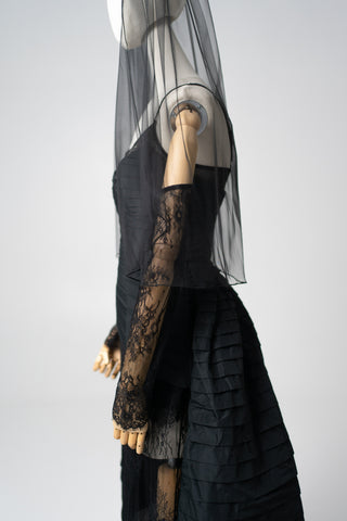 An exquisite black corset set with tulle texture and a luxurious train that creates a dramatic and architectural silhouette