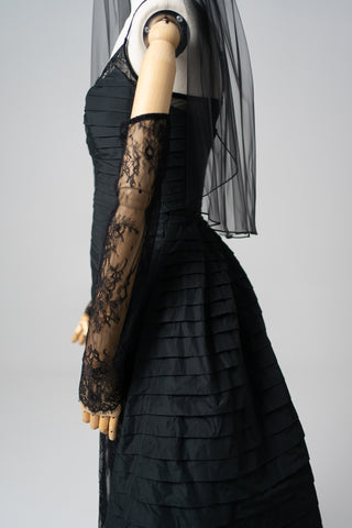 An exquisite black corset set with tulle texture and a luxurious train that creates a dramatic and architectural silhouette