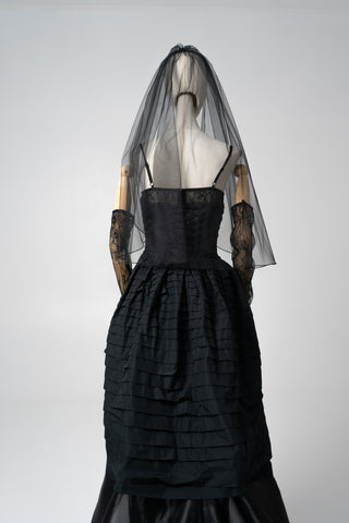 An exquisite black corset set with tulle texture and a luxurious train that creates a dramatic and architectural silhouette - designer piece by Caribis