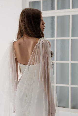 Lightweight cape made of tulle with floral accents and elongated trains