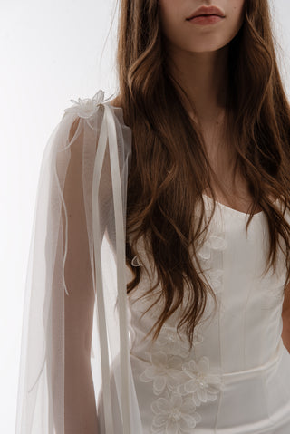Lightweight cape made of tulle with floral accents and elongated trains